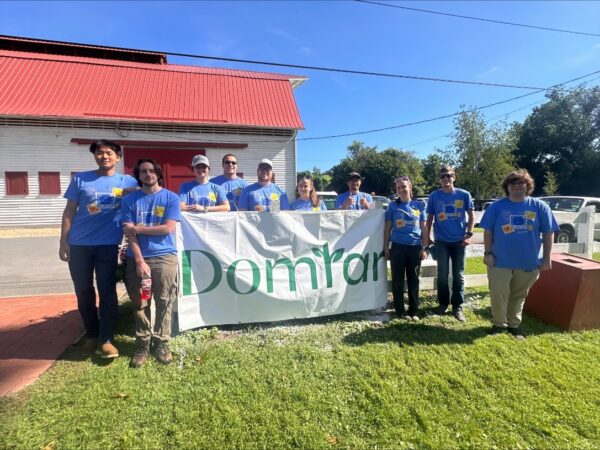 Domtar Kingsport interns and employees gather with a Domtar banner during the 2026 Kingsport Fun Fest.